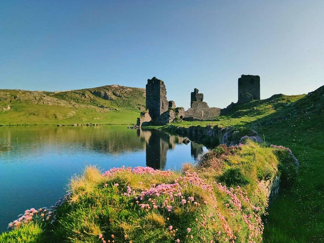 Irish ruins near a lake outside.