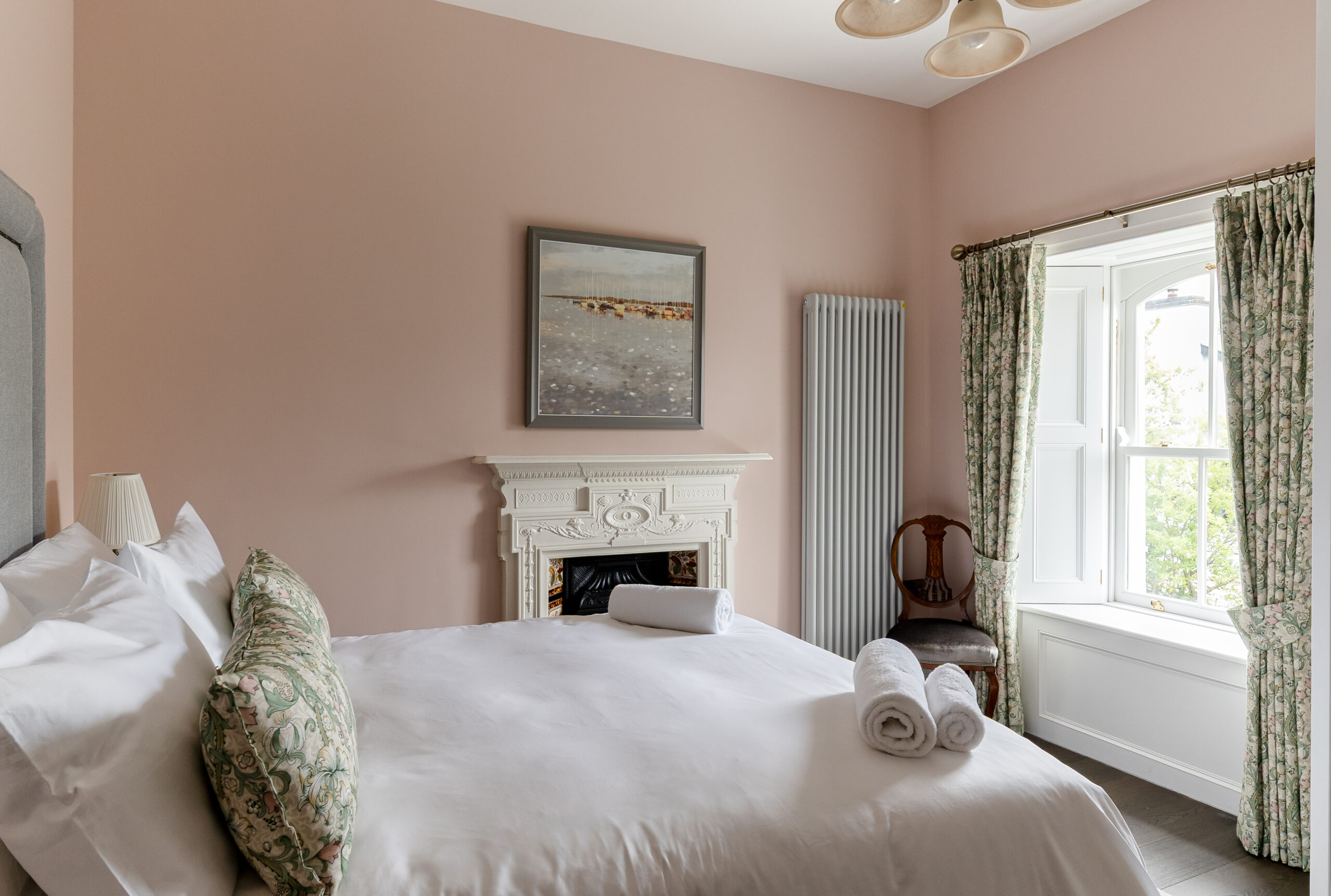 A pink bedroom with a double bed.