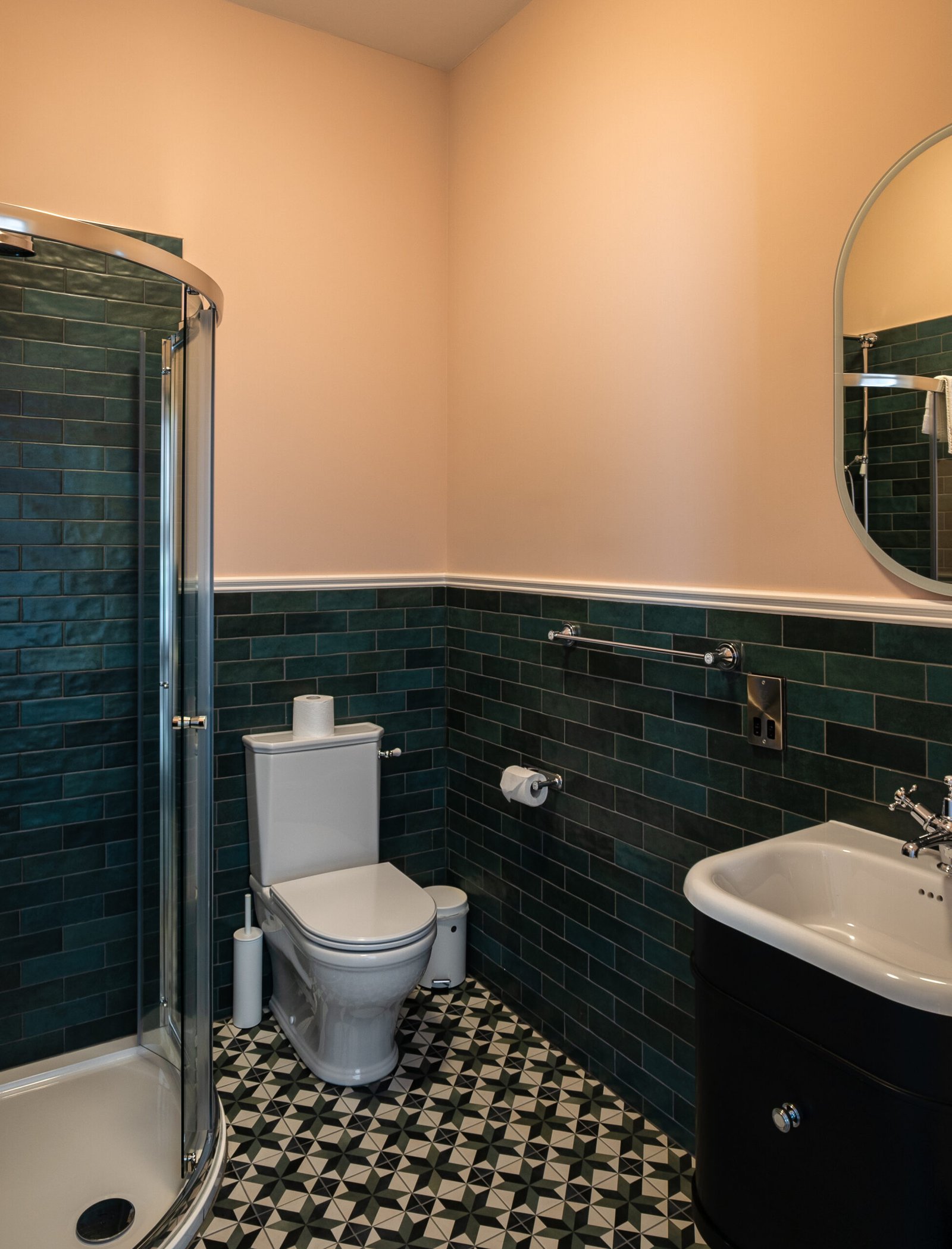 A yellow bathroom with dark blue tiles.