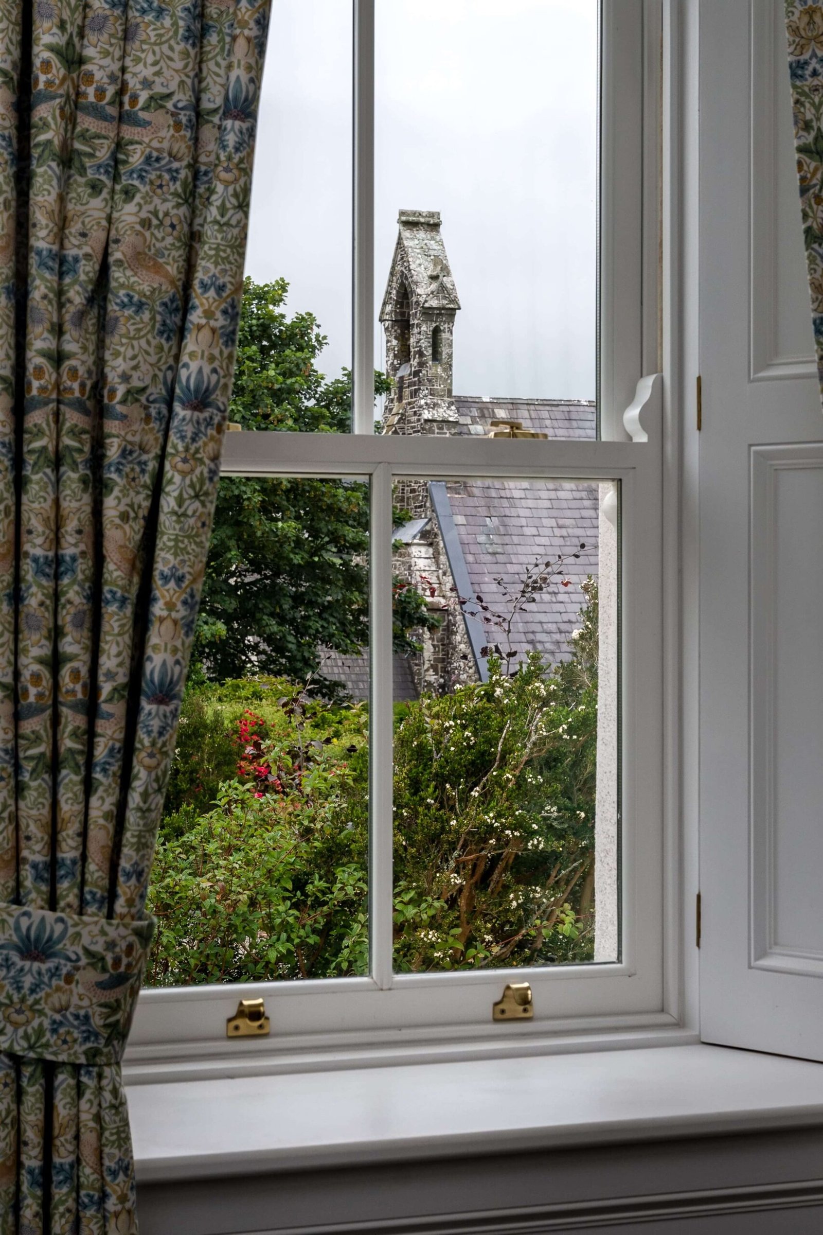 Close up of a white window over a house.