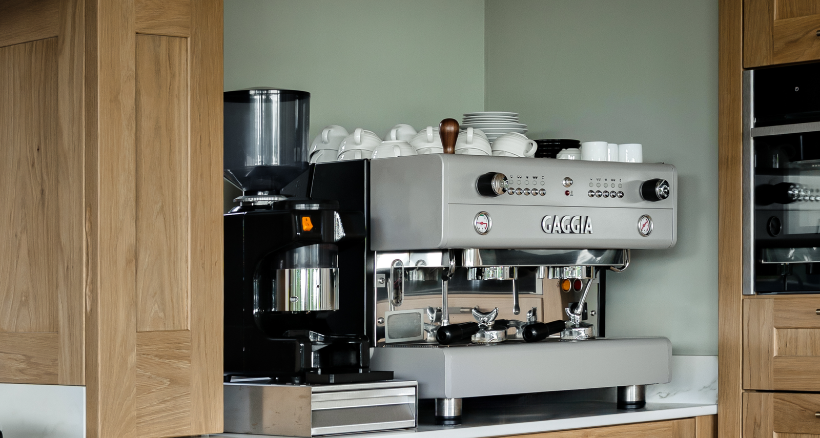 Close up of two coffee machines in a kitchen.