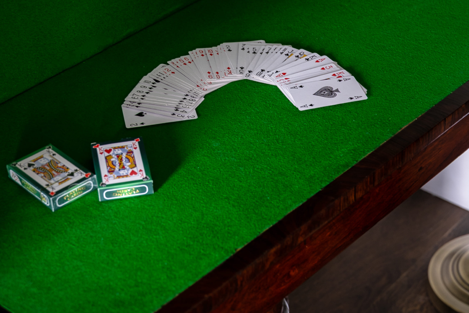 Playing cards on a green surface.