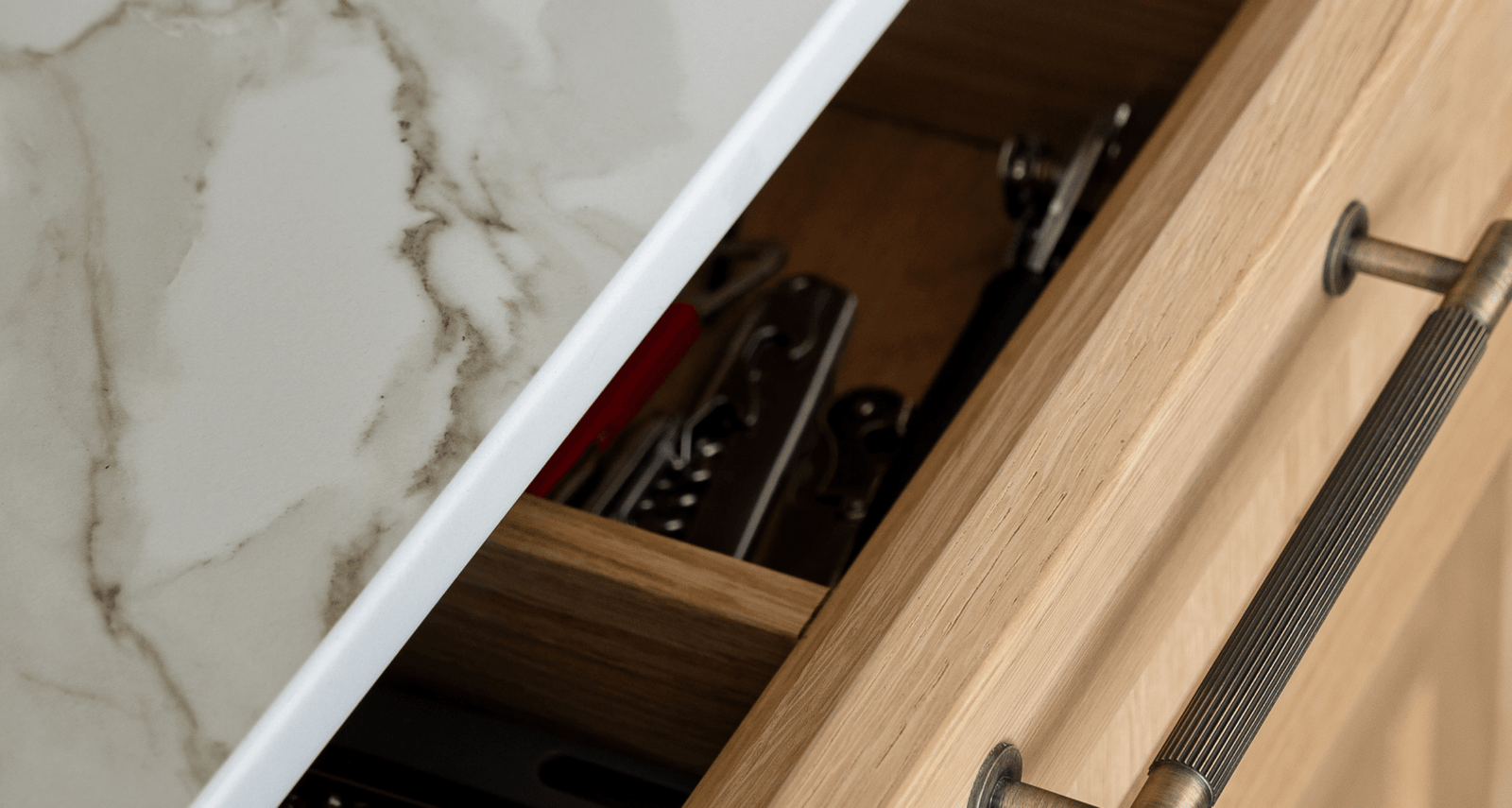 Close up of a brown cabinet in a white kitchen.
