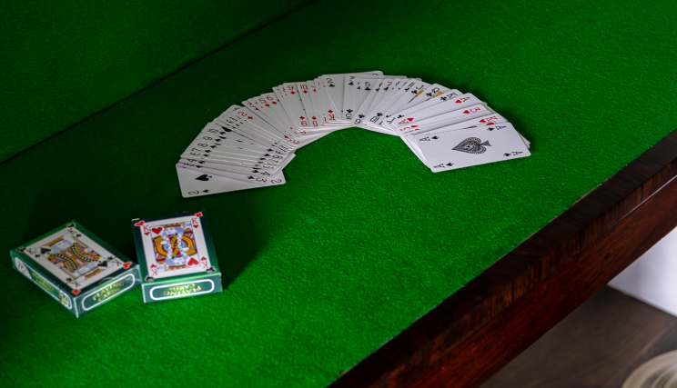 Playing cards on a green surface.