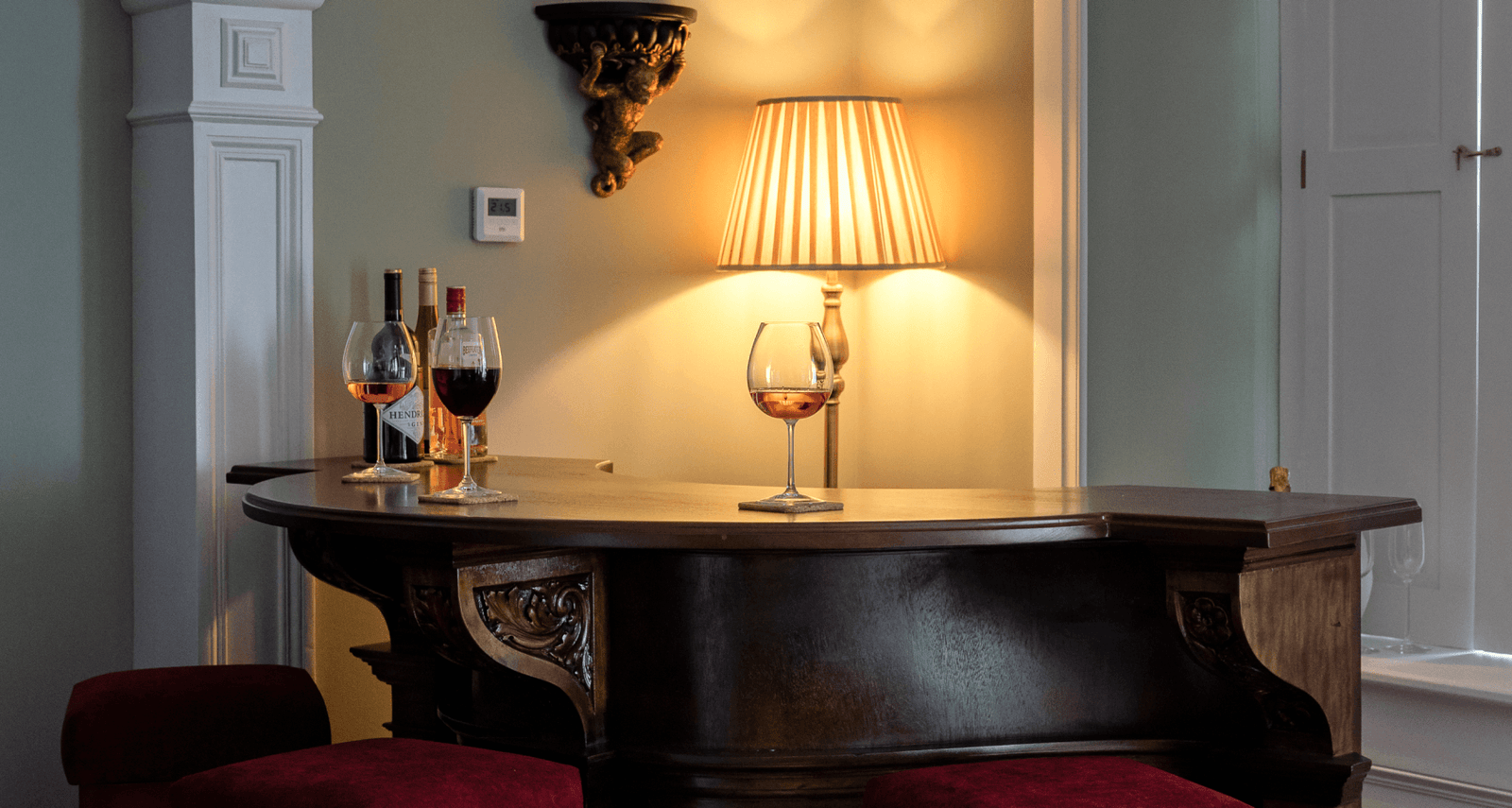 A close up of a small bar with wines on top of it.